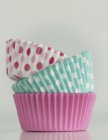 Stack of Cupcake cases against grey background — Stock Photo