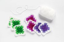 Crocheted doilies and yarn against white background — Stock Photo