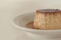 Closeup of tasty egg custard dessert against white background — Stock Photo