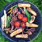 Barbecue with meat, vegetables and bread, top view — Stock Photo