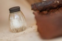 Close-up of old fashioned salt shaker over table — Stock Photo