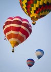 Scenic view of hot air balloons mid air — Stock Photo