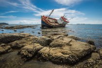 Scenic view of shipwreck near rocky coast — Stock Photo