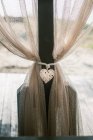 Wicker love heart on outdoor curtains — Stock Photo