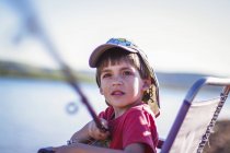 Boy sitting in chair outdoors and fishing — Stock Photo