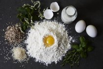 Farina, uova, latte, erbe aromatiche, riso e semi misti sulla tavola di legno — Foto stock