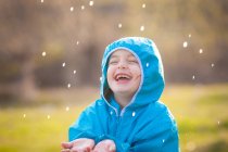 Ragazza che indossa impermeabile godendo la pioggia — Foto stock