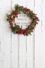 God bless our home sign on door surrounded by wreath — Stock Photo