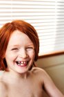 Portrait of smiling shirtless redheaded boy — Stock Photo