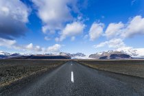 Мальовничим видом порожній-роуд, гірський хребет у фоновому режимі, Ісландія — стокове фото