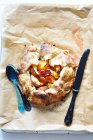Top view of apricot and peach tart on cooking paper — Stock Photo