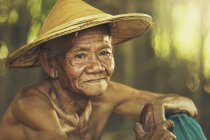 Portrait of senior asian man in traditional hat — Stock Photo