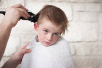 Boy getting a buzz haircut by his father — Stock Photo