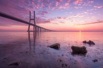 Vasco da Gama Bridge silhouetted against morning sky, Lisbon, Portugal — Stock Photo