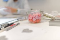 Jar of fraise tagada sweets on a desk — Stock Photo