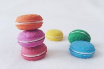Stack of multi-colored macaroons against white background — Stock Photo