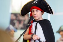 Boy dressed as pirate performing on stage — Stock Photo