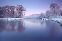 Ireland, Cootehill, scenic view of frozen dromore river at sunset — Stock Photo