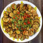 Roasted eggplant salad with tomatoes and basil oil, top view — Stock Photo