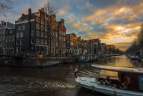 Scenic view of canal at sunset, Amsterdam, Holland — Stock Photo