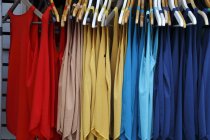Multi-colored vests hanging in market — Stock Photo