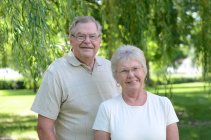 Portrait of senior caucasian couple smiling at park — Stock Photo