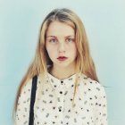 Portrait of blond teenage girl wearing patterned shirt — Stock Photo