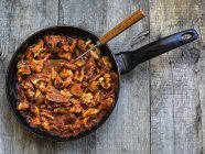 Pork ears and tomato sauce in frying pan — Stock Photo