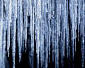 Closeup view of arctic icicles against black background — Stock Photo