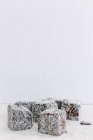 Coconut Covered Lamingtons Against White Wall — Stock Photo