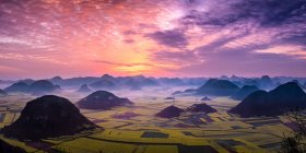Beautiful sunrise over oilseed rape fields, Luoping Yunnan, China — Stock Photo