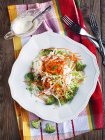 Coleslaw and dressing with mayonnaise and low fat yogurt on plate — Stock Photo