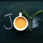 To view of joy word with coffee and fir tree branch — Stock Photo