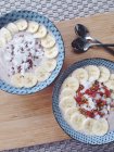 Raw oat porridge on plates over table — Stock Photo