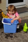 Girl crouching next to a bucket ready to clean — Stock Photo