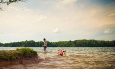 Man and dog walking in a lake, Loudon, Tennessee, USA — Stock Photo