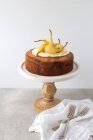Pear sponge cake on a cake stand — Stock Photo