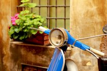 Italy, Rome, Close up of motor scooter against building wall — Stock Photo