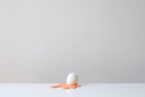 Conceptual egg shell on yellow yolk — Stock Photo