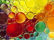 Closeup view of colorful oil bubbles in water — Stock Photo