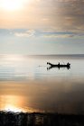 Fisherman sitting in boat at sunset, Malaysia, Johorm, Muar, Tanjung Mas — Stock Photo