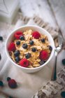 Close-up of Cornflakes with blueberries and raspberries in bowl — Stock Photo