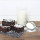 Chocolate brownies dusted with icing sugar — Stock Photo
