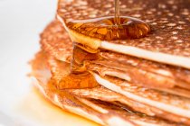 Close-up of stacked pancakes with maple syrup — Stock Photo