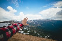 Scenic landscape with human hand on foreground — Stock Photo