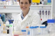 Portrait of confident mid adult caucasian woman at work in laboratory — Stock Photo