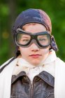 Portrait of boy wearing leather pilot cap and goggles — Stock Photo