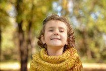 Portrait of Pretty little girl smiling in park — Stock Photo