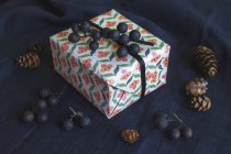 Closeup view Gift box on black textile — Stock Photo