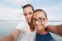 Portrait of mother and son in eyeglasses at vacation — Stock Photo